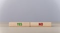 The wooden block shows yes or no letters. The concept of making decisions, voting, and thinking right and wrong. Business options Royalty Free Stock Photo