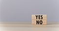 The wooden block shows yes or no letters. The concept of making decisions, voting, and thinking right and wrong. Business options Royalty Free Stock Photo