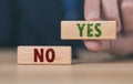 The wooden block shows yes or no letters. The concept of making decisions, voting, and thinking right and wrong. Business options Royalty Free Stock Photo