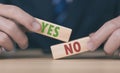 The wooden block shows yes or no letters. The concept of making decisions, voting, and thinking right and wrong. Business options Royalty Free Stock Photo