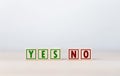 The wooden block shows yes or no letters. The concept of making decisions, voting, and thinking right and wrong. Business options Royalty Free Stock Photo