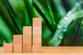 Wooden block stacking as step stair on wooden table. Business concept