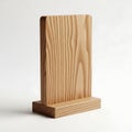 A wooden block standing upright on a flat surface against a white background Royalty Free Stock Photo