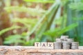 Wooden block with a TAX word and coins