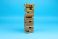 Wooden block tower on a blue background. Royalty Free Stock Photo