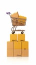 Wooden block with trolley and paper boxes symbolize shopping success