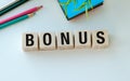 A wooden block with the word Bonus written on it. Royalty Free Stock Photo