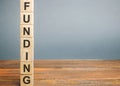 Wooden block with the word Funding. The concept of providing financial resources to organizations and enterprises. Credit,