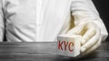 Wooden block with the word KYC - Know Your Customer / Client. Verify the identity, suitability and risks involved with maintaining Royalty Free Stock Photo