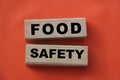 Wooden block with words FOOD SAFETY on tomato red. Healthcare concept