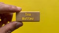 Wooden block with the words You matter. Motivational concept