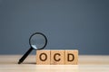 Wooden blocks with the abbreviation OCD. Obsessive compulsive disease. Mental health and psychiatry
