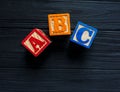 Wooden blocks with A B C letters, abacus toys for creativity development on black background. Educational games for kindergarten, Royalty Free Stock Photo