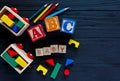 Wooden blocks with A B C letters, toys for creativity development on black background. Educational games for kindergarten, Royalty Free Stock Photo