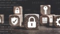 Wooden cubes displaying cyber security icons on a binary code background. Royalty Free Stock Photo