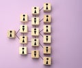 Wooden blocks with figures on a lilac background, hierarchical organizational structure of management, gender balance, effective Royalty Free Stock Photo