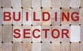 Wooden blocks form the words `building sector`. Beautiful wooden background