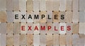 Wooden blocks form the words `examples, examples`. Beautiful wooden background