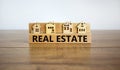 Wooden blocks form the words `real estate`, miniature house, wooden table. Beautiful white background, copy space. Business and Royalty Free Stock Photo