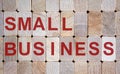 Wooden blocks form the words `small business`. Beautiful wooden background