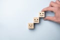 Wooden blocks with the happy face smile face symbol symbol on the table, evaluation, Increase rating, Customer experience