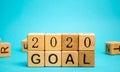 Wooden blocks with the inscription 2020 goal. The concept of achieving business goals. Execution of a business plan.