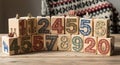 Wooden blocks with numbers and festive decorations on a wooden table Royalty Free Stock Photo