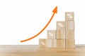 Wood blocks with percentage sign and orange arrow up for business and financial growth, interest rate increase, inflation