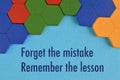 Wooden blocks and phrase written with FORGET THE MISTAKE, REMEMBER THE LESSON