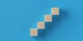 Wooden blocks rising steps over blue background, business success, growth or development progress concept Royalty Free Stock Photo