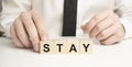 The wooden blocks say STAY . Concept image a wooden block and word - STAY Royalty Free Stock Photo