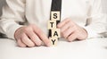 The wooden blocks say STAY . Concept image a wooden block and word - STAY Royalty Free Stock Photo