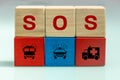 Wooden blocks with SOS inscription and icons of fire department, police and ambulance, Rescue concept, Relief services and Social