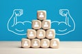 Wooden blocks stacked as pyramid hierarchy with people icons. Power of teamwork, solidarity or cooperation in business. Royalty Free Stock Photo