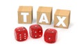 Wooden blocks with TAX letters and red dices. Avoiding paying taxes as a hazard or gambling concept. 3D rendering