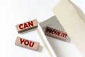 Wooden blocks with text Can You Prove It in a box on a white background