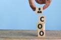 Wooden blocks with text COO stands for Chief Operating Officer