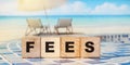 Wooden Blocks with the text: Fees. Taxes business concept