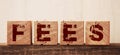 Wooden Blocks with the text: Fees. Taxes and finance concept Royalty Free Stock Photo