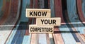 On wooden blocks the text KNOW YOUR COMPETITORS