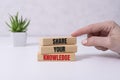 wooden blocks with text SHARE YOUR KNOWLEDGE on white