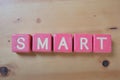 Wooden Blocks with the text SMART in pink background Royalty Free Stock Photo