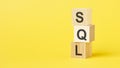 wooden blocks with the text sql - short for structured query language on a bright yellow background Royalty Free Stock Photo