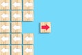 Wooden blocks with white and red arrows. Different directions. Leadership success concept. Innovative solution. Individual concept