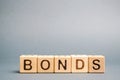 Wooden blocks with the word Bonds. A bond is a security that indicates that the investor has provided a loan to the issuer. Royalty Free Stock Photo