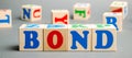 Wooden blocks with the word Bonds. A bond is a security that indicates that the investor has provided a loan to the issuer. Royalty Free Stock Photo