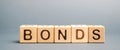 Wooden blocks with the word Bonds. A bond is a security that indicates that the investor has provided a loan to the issuer.