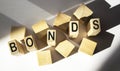 Wooden blocks with the word Bonds on a white background. A bond is a security that indicates that an investor has provided a loan Royalty Free Stock Photo