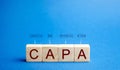 Wooden blocks with the word CAPA. Corrective and Preventive action plans. Business management concept. Strategy and efficiency. Royalty Free Stock Photo