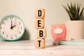 Wooden blocks with the word Debt. Reduction or restructuring of debt.
